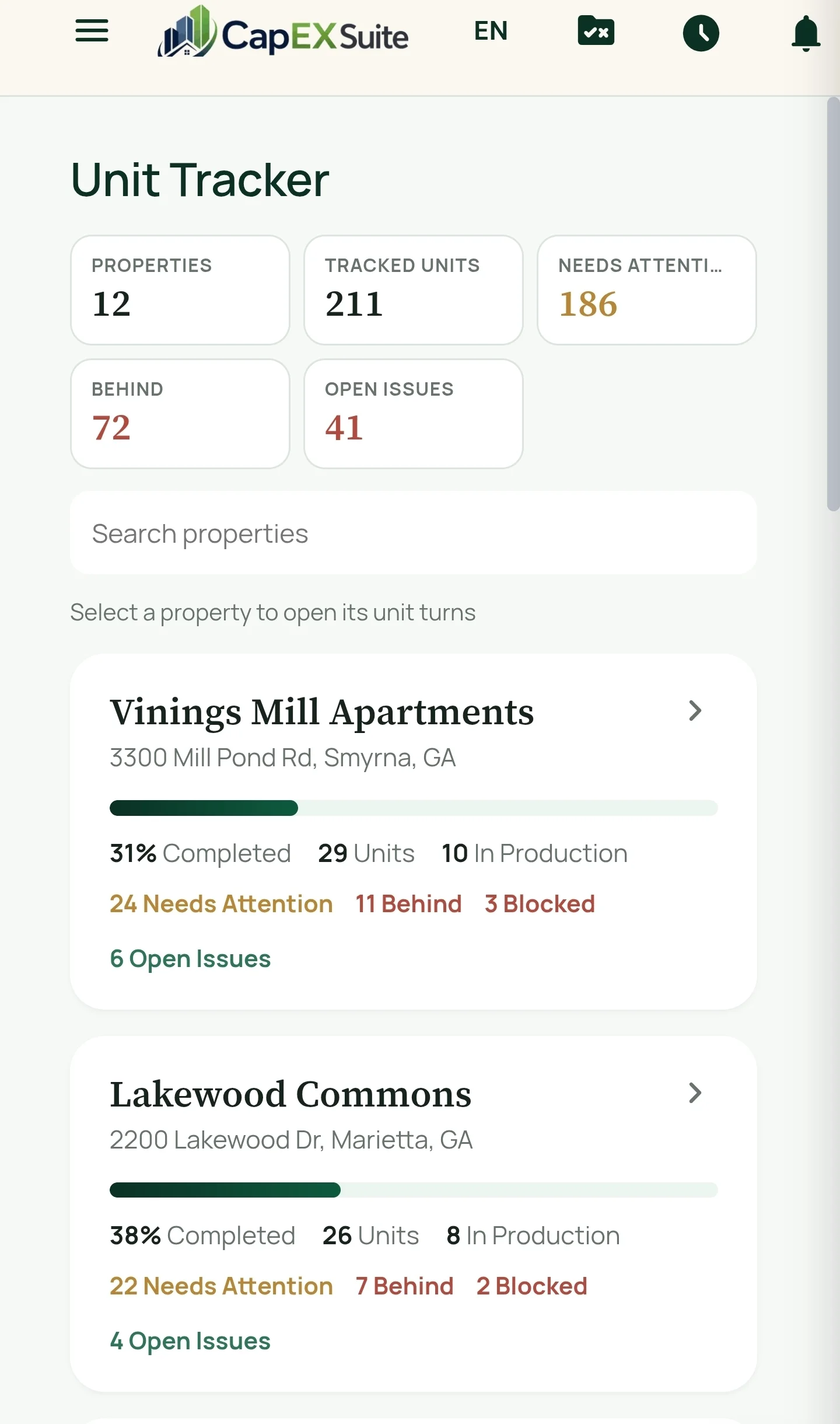 The Unit Tracker on a phone: portfolio totals, then each property with completion percentage, units in production, needs-attention, behind, blocked and open-issue counts.